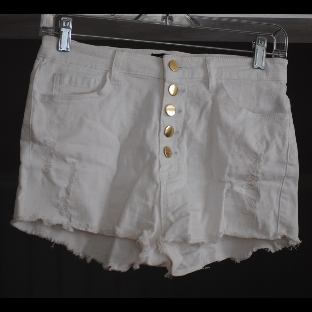 Distressed white denim shorts with gold button fly